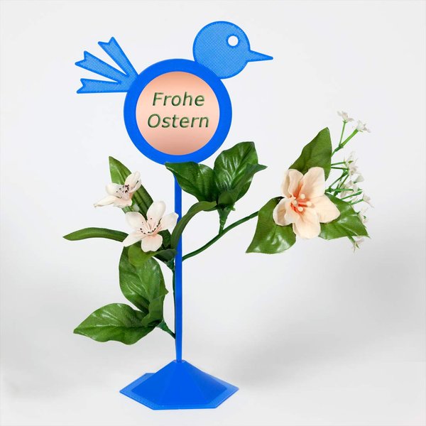 Blumenstecker Vogel blau mit Standfuß-Dekorationsbeispiel mit Fotoaufkleber "Frohe Ostern" und lachsfarbenen Blüten und grünen Blättern